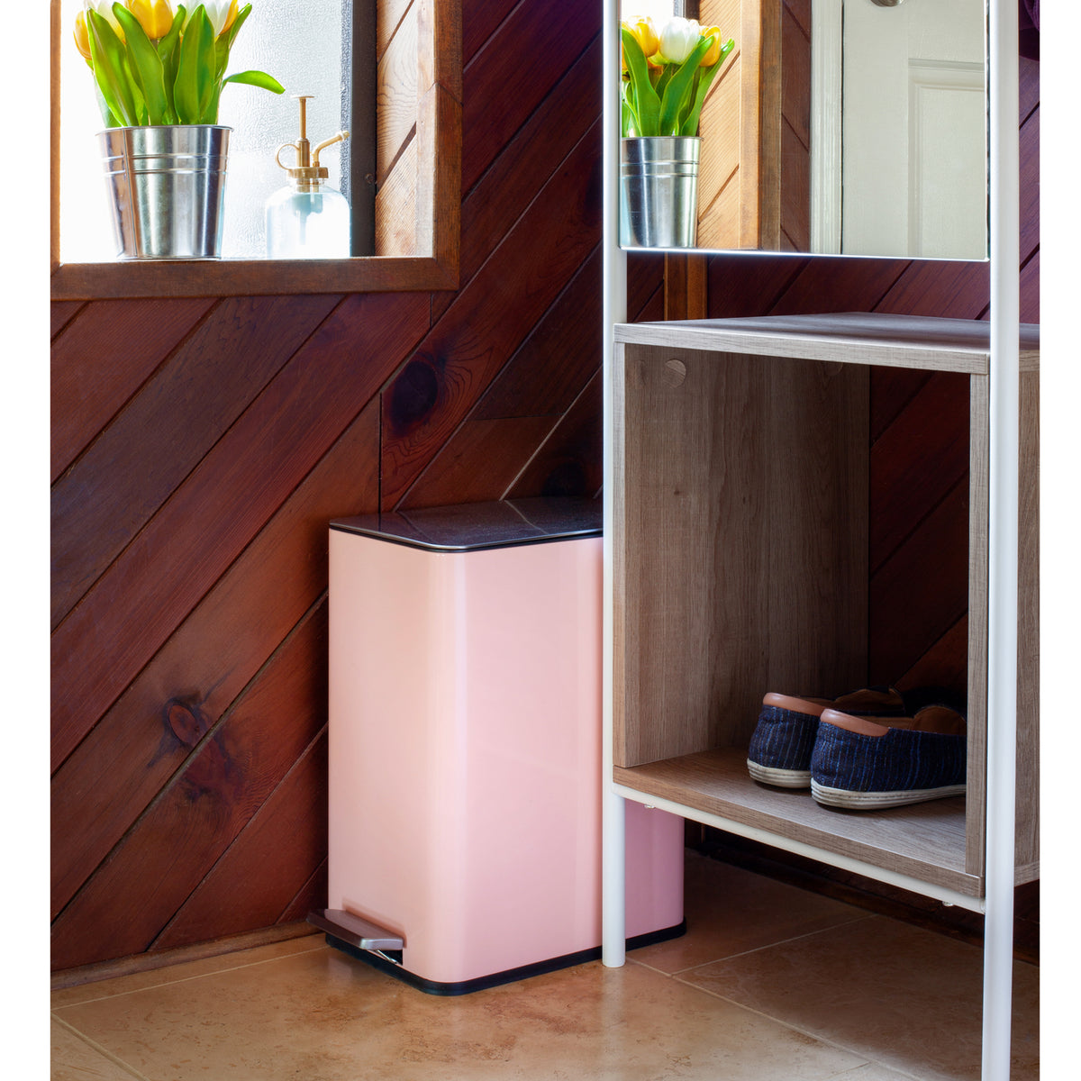 Rose pink slim trash can in a small bedroom