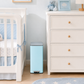 Baby blue slim trash can in a nursery