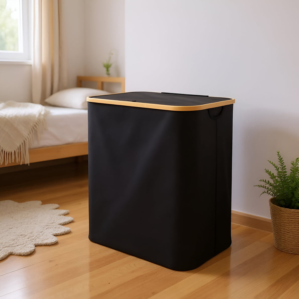 Large black laundry hamper with lid in modern bedroom