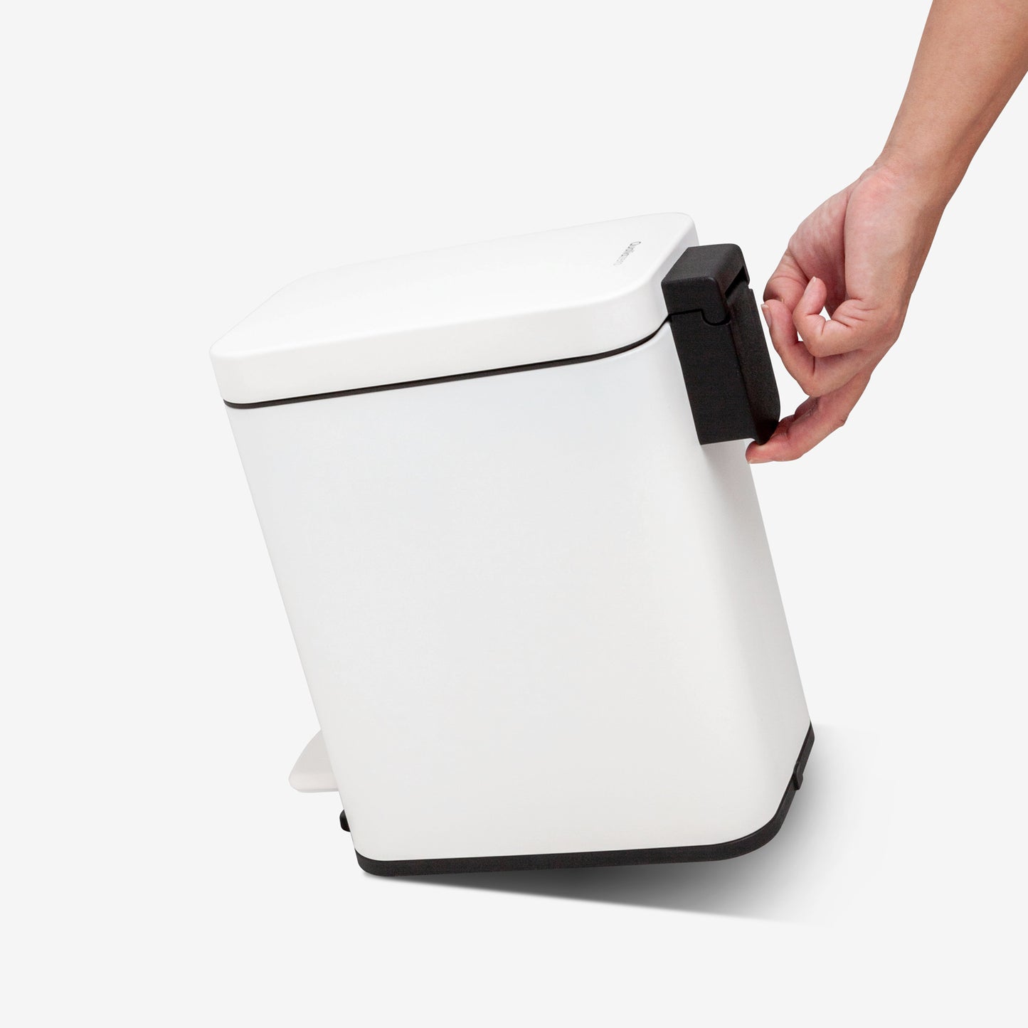 Built-in rear handle on compact white bathroom trash can