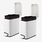 Removable inner buckets inside two small white bathroom trash cans
