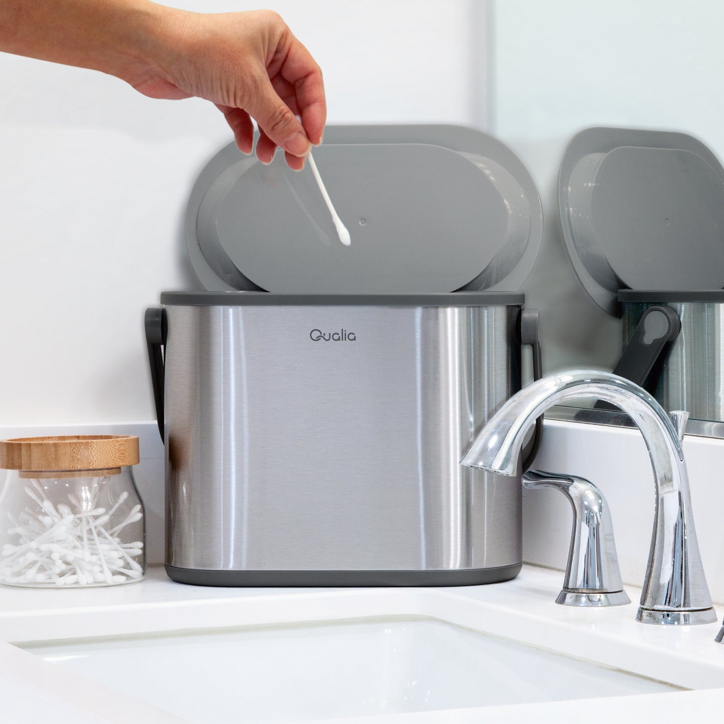 Stainless steel countertop compost bin beside bathroom sink