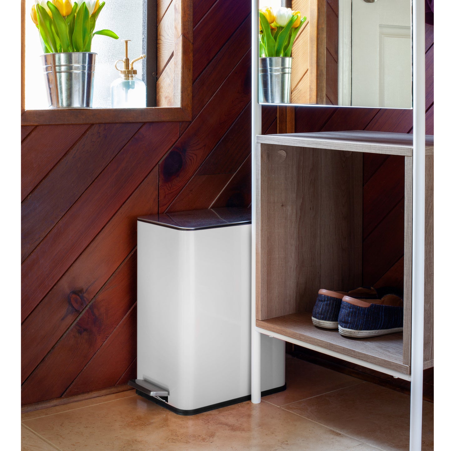 White slim step trash can fitting neatly in a narrow household space